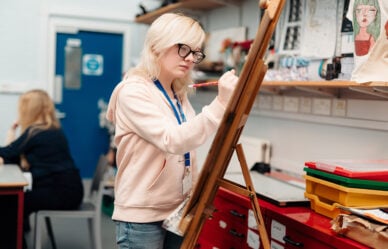 14+ students painting in art and design class